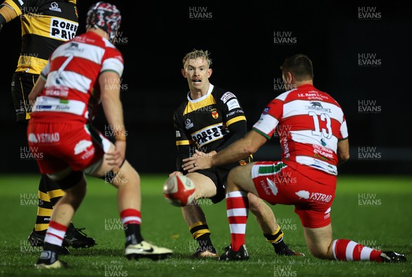 120925 - Newport RFC v Llandovery RFC - Super Rygbi Cymru SRC - Carwyn Penny of Newport threads the ball past Adam Warren of Llandovery 