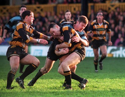 031294 - Newport v Cardiff - Andy Griffiths of Newport is tackled by Chris John of Cardiff