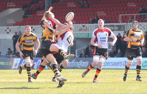 060413 - Newport RFC v Carmarthen Quins, Principality Premiership - Newport's Tom Hancock challenges Carmarthen Quins' Aidan Laxton and Carmarthen Quins' James Dixon for the ball