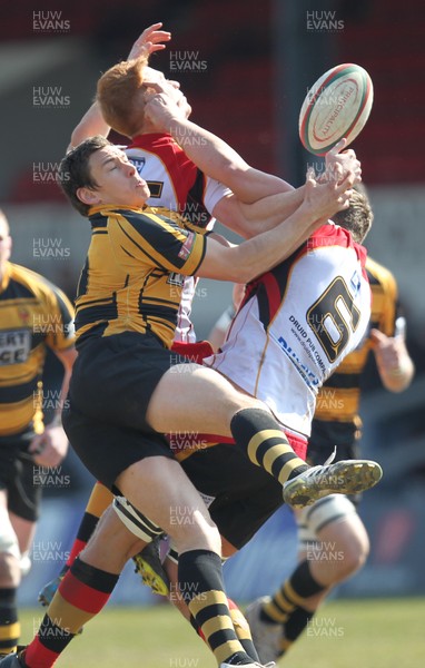 060413 - Newport RFC v Carmarthen Quins, Principality Premiership - Newport's Tom Hancock challenges Carmarthen Quins' Aidan Laxton and Carmarthen Quins' James Dixon for the ball