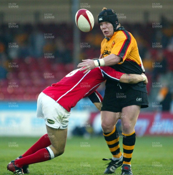 220403 - Newport v Llanelli - Welsh Premiership - Newport's David Patterson loses control as Michael Phillips tackles