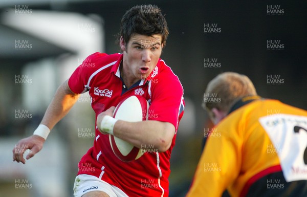 220403 - Newport v Llanelli - Welsh Premiership - Llanelli's Michael Phillips bears down on James Richards