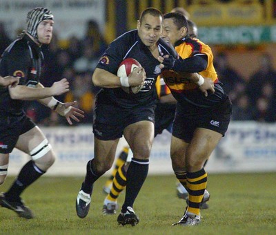 050203 - Newport v Neath - Welsh Premiership - Neath's Dave Tiueti is tackled by Ofisa Tonu'u