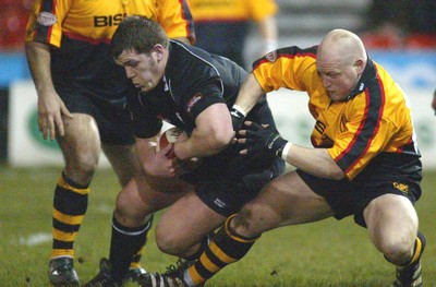 050203 - Newport v Neath - Welsh Premiership - Neath's Paul James is tackled by Paul Young 