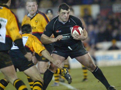 050203 - Newport v Neath - Welsh Premiership - Neath's Rowland Phillips looks for support as Shane Howarth closes in