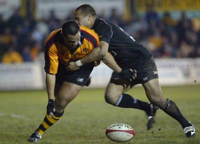 050203 - Newport v Neath - Welsh Premiership - Newport's Ofisa Tonu'u is forced off the ball by Dave Tiueti