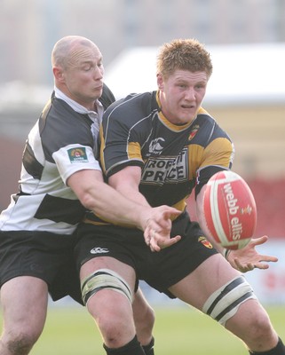 10.04.10 Newport v Neath... Newport's Andrew Coombs is tackled by Kevin Farrell. 