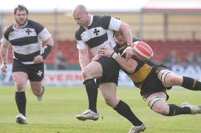 10.04.10 Newport v Neath... Newport's Andrew Coombs tackles  Kevin Farrell. 