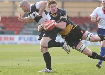 10.04.10 Newport v Neath... Newport's Andrew Coombs tackles  Kevin Farrell. 