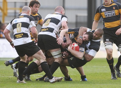 10.04.10 Newport v Neath... Newport's Mike Poole is tackled by Nathan Brew. 