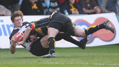 10.04.10 Newport v Neath... Newport's Adam Hughes puts in a crunching tackle on Alec Jenkins. 