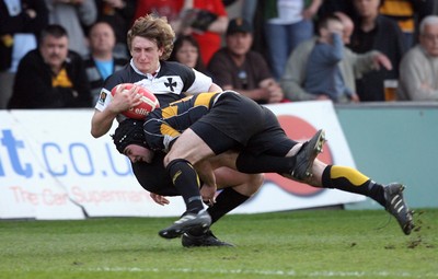 10.04.10 Newport v Neath... Newport's Adam Hughes puts in a crunching tackle on Alec Jenkins. 