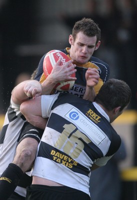 10.04.10 Newport v Neath... Newport's Mike Poole is tackled by Gareth King(15) and Gareth Gravell. 