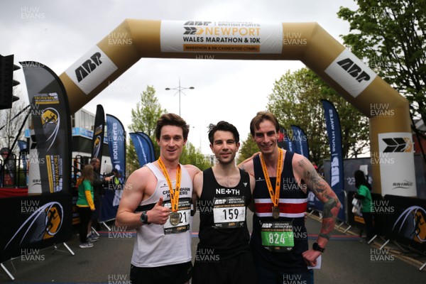 290418 - Newport Marathon -  James Carpenter (middle) celebrates winning the Newport Wales Marathon with runners up Jonathan Barnes (L) and Luke Williams (R) 