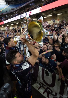 240525 - Northampton Saints v Union Bordeaux-Begles, EPCR Champions Cup Final - Matthieu Jalibert of Union Bordeaux-Begles celebrates with the trophy and fans as they win the Investec Champions Cup