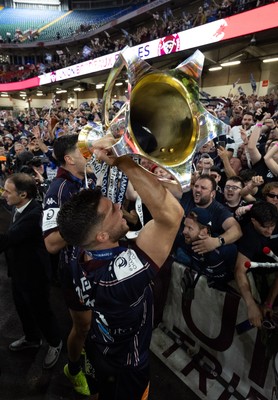 240525 - Northampton Saints v Union Bordeaux-Begles, EPCR Champions Cup Final - Matthieu Jalibert of Union Bordeaux-Begles celebrates with the trophy and fans as they win the Investec Champions Cup