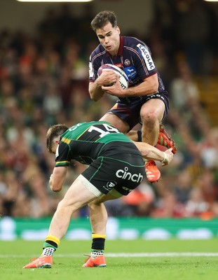 240525 - Northampton Saints v Union Bordeaux-Begles, EPCR Champions Cup Final - Damian Penaud of Union Bordeaux-Begles takes the ball as Tommy Freeman of Northampton Saints closes in