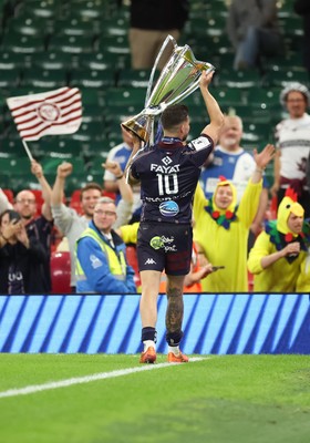 240525 - Northampton Saints v Union Bordeaux-Begles, EPCR Champions Cup Final - Matthieu Jalibert of Union Bordeaux-Begles lifts the trophy as he celebrates with fans
