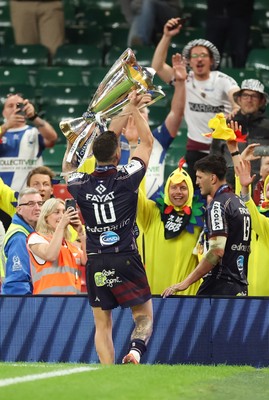 240525 - Northampton Saints v Union Bordeaux-Begles, EPCR Champions Cup Final - Matthieu Jalibert of Union Bordeaux-Begles lifts the trophy as he celebrates with fans
