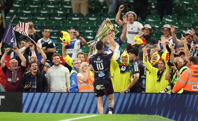 240525 - Northampton Saints v Union Bordeaux-Begles, EPCR Champions Cup Final - Matthieu Jalibert of Union Bordeaux-Begles lifts the trophy as he celebrates with fans
