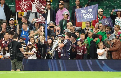 240525 - Northampton Saints v Union Bordeaux-Begles, EPCR Champions Cup Final - Marko Gazzotti of Union Bordeaux-Begles lifts the trophy as he celebrates with fans