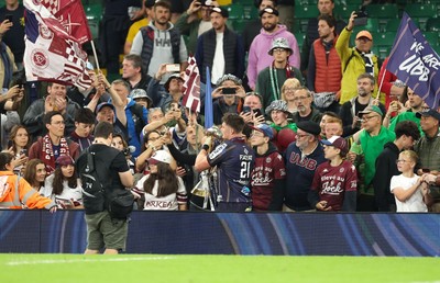 240525 - Northampton Saints v Union Bordeaux-Begles, EPCR Champions Cup Final - Marko Gazzotti of Union Bordeaux-Begles lifts the trophy as he celebrates with fans