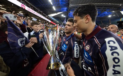 240525 - Northampton Saints v Union Bordeaux-Begles, EPCR Champions Cup Final - Matthieu Jalibert and Louis Bielle-Biarrey of Union Bordeaux-Begles celebrate with the trophy and fans