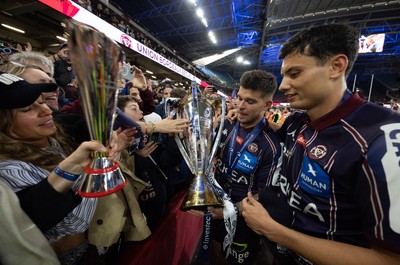 240525 - Northampton Saints v Union Bordeaux-Begles, EPCR Champions Cup Final - Matthieu Jalibert and Louis Bielle-Biarrey of Union Bordeaux-Begles celebrate with the trophy and fans