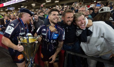 240525 - Northampton Saints v Union Bordeaux-Begles, EPCR Champions Cup Final - Union Bordeaux-Begles players celebrate with the trophy and fans