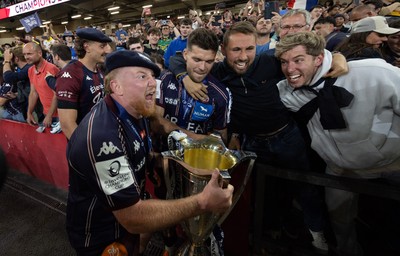 240525 - Northampton Saints v Union Bordeaux-Begles, EPCR Champions Cup Final - Union Bordeaux-Begles players celebrate with the trophy and fans