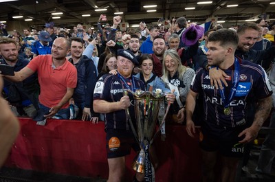 240525 - Northampton Saints v Union Bordeaux-Begles, EPCR Champions Cup Final - Union Bordeaux-Begles players celebrate with the trophy and fans