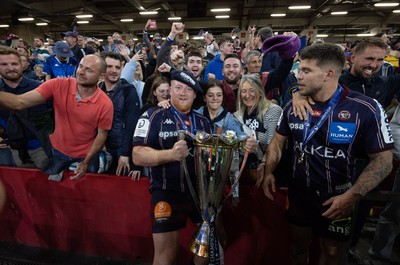 240525 - Northampton Saints v Union Bordeaux-Begles, EPCR Champions Cup Final - Union Bordeaux-Begles players celebrate with the trophy and fans