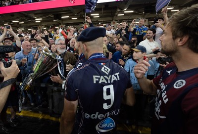 240525 - Northampton Saints v Union Bordeaux-Begles, EPCR Champions Cup Final - Maxime Lucu of Union Bordeaux-Begles celebrates with the trophy and fans