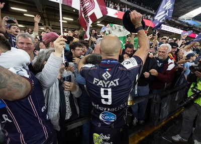 240525 - Northampton Saints v Union Bordeaux-Begles, EPCR Champions Cup Final - Maxime Lucu of Union Bordeaux-Begles celebrates with the trophy and fans