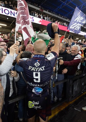 240525 - Northampton Saints v Union Bordeaux-Begles, EPCR Champions Cup Final - Maxime Lucu of Union Bordeaux-Begles celebrates with the trophy and fans