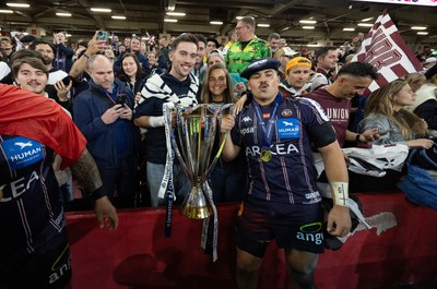 240525 - Northampton Saints v Union Bordeaux-Begles, EPCR Champions Cup Final - Union Bordeaux-Begles players celebrate with the trophy and fans