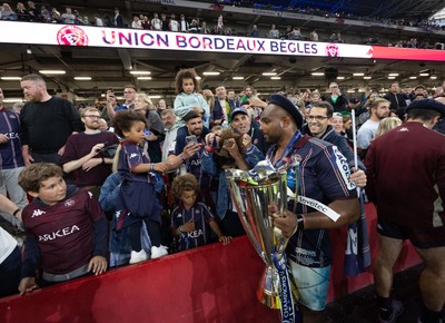 240525 - Northampton Saints v Union Bordeaux-Begles, EPCR Champions Cup Final - Union Bordeaux-Begles players celebrate with the trophy and fans