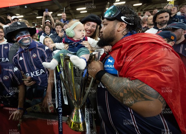240525 - Northampton Saints v Union Bordeaux-Begles, EPCR Champions Cup Final - Ben Tameifuna of Union Bordeaux-Begles celebrates with the trophy and family as they win the Investec Champions Cup