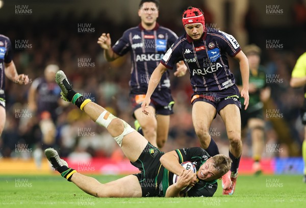 240525 - Northampton Saints v Union Bordeaux-Begles, EPCR Champions Cup Final - Tom Litchfield of Northampton Saints beats Louis Bielle-Biarrey of Union Bordeaux-Begles to the ball