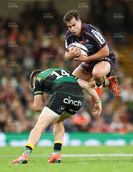 240525 - Northampton Saints v Union Bordeaux-Begles, EPCR Champions Cup Final - Damian Penaud of Union Bordeaux-Begles takes the ball as Tommy Freeman of Northampton Saints closes in