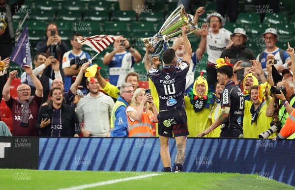 240525 - Northampton Saints v Union Bordeaux-Begles, EPCR Champions Cup Final - Matthieu Jalibert of Union Bordeaux-Begles lifts the trophy as he celebrates with fans