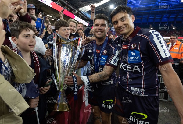 240525 - Northampton Saints v Union Bordeaux-Begles, EPCR Champions Cup Final - Matthieu Jalibert and Louis Bielle-Biarrey of Union Bordeaux-Begles celebrate with the trophy and fans