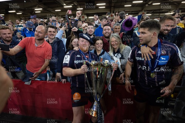 240525 - Northampton Saints v Union Bordeaux-Begles, EPCR Champions Cup Final - Union Bordeaux-Begles players celebrate with the trophy and fans
