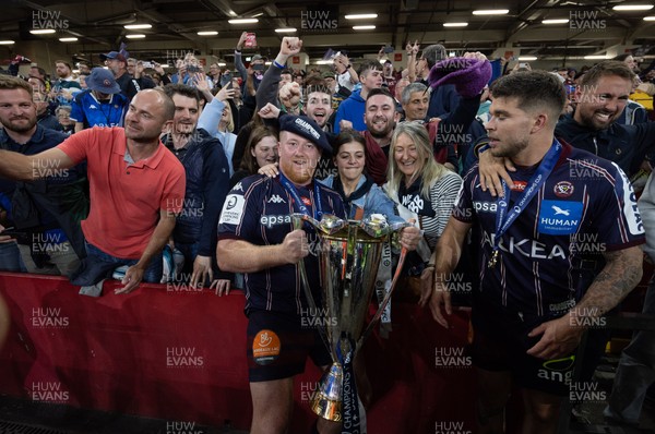 240525 - Northampton Saints v Union Bordeaux-Begles, EPCR Champions Cup Final - Union Bordeaux-Begles players celebrate with the trophy and fans