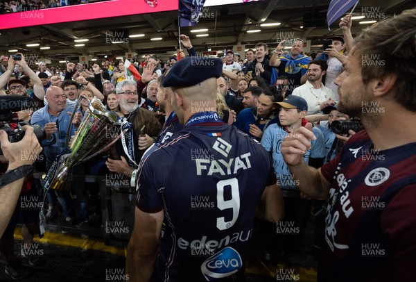 240525 - Northampton Saints v Union Bordeaux-Begles, EPCR Champions Cup Final - Maxime Lucu of Union Bordeaux-Begles celebrates with the trophy and fans