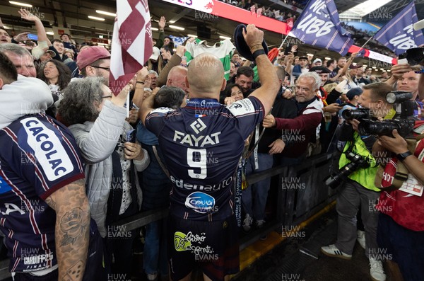 240525 - Northampton Saints v Union Bordeaux-Begles, EPCR Champions Cup Final - Maxime Lucu of Union Bordeaux-Begles celebrates with the trophy and fans