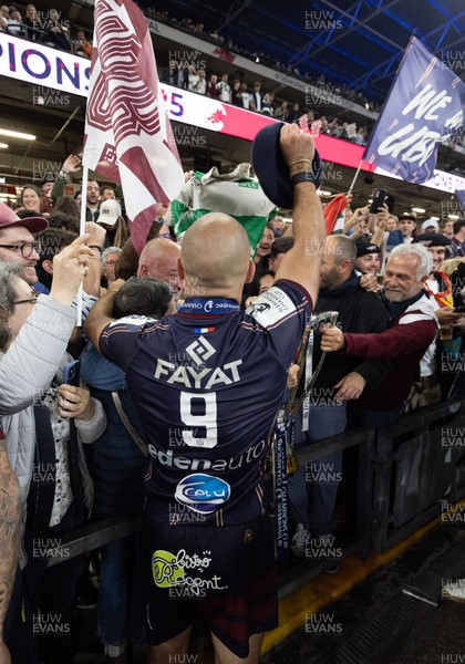 240525 - Northampton Saints v Union Bordeaux-Begles, EPCR Champions Cup Final - Maxime Lucu of Union Bordeaux-Begles celebrates with the trophy and fans