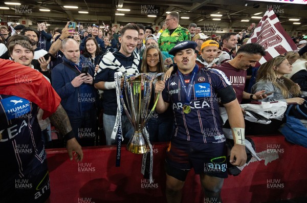 240525 - Northampton Saints v Union Bordeaux-Begles, EPCR Champions Cup Final - Union Bordeaux-Begles players celebrate with the trophy and fans
