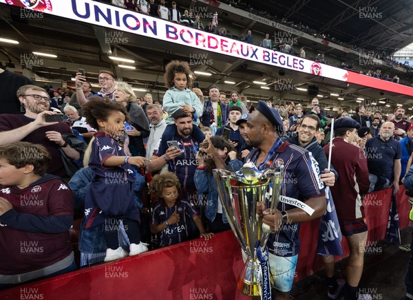 240525 - Northampton Saints v Union Bordeaux-Begles, EPCR Champions Cup Final - Union Bordeaux-Begles players celebrate with the trophy and fans