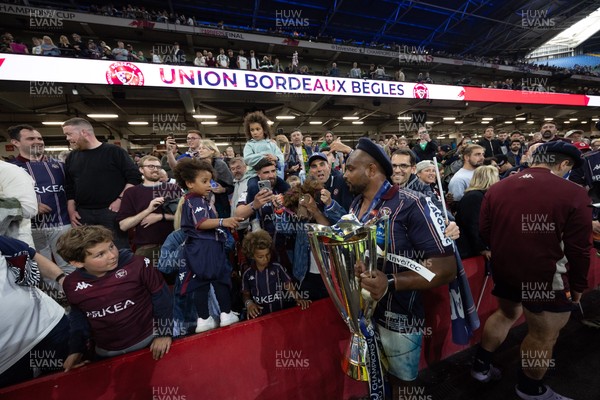 240525 - Northampton Saints v Union Bordeaux-Begles, EPCR Champions Cup Final - Union Bordeaux-Begles players celebrate with the trophy and fans